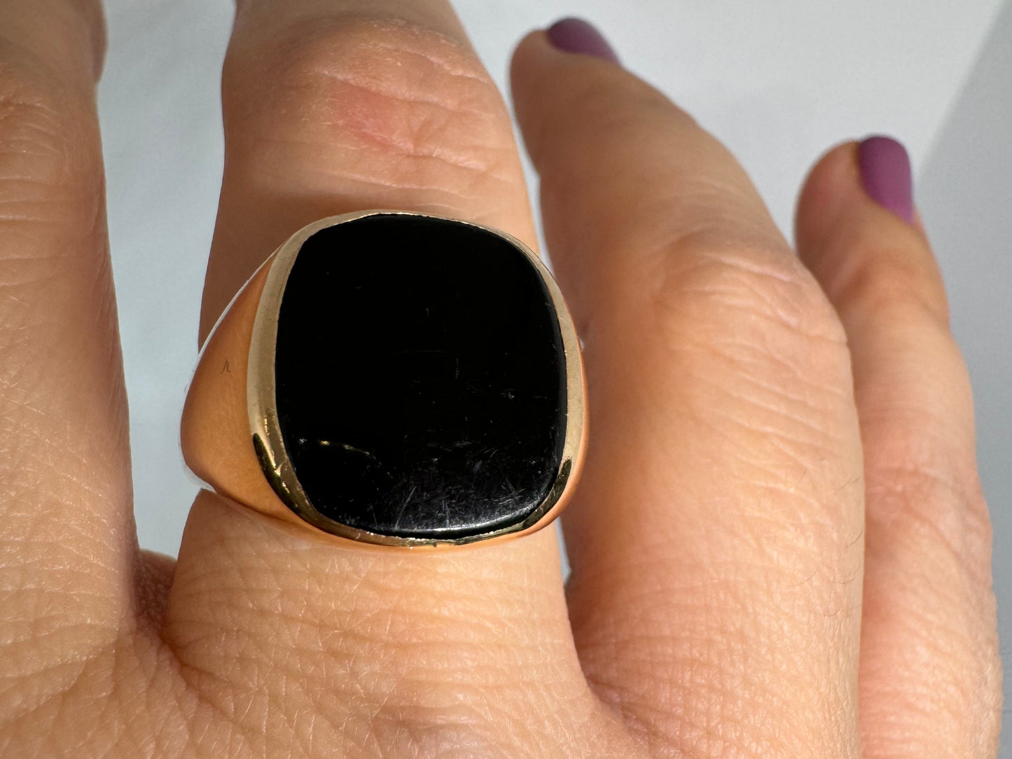 14K bold gold ring set with a smooth, square-shaped black Onyx that creates a sleek and striking look.