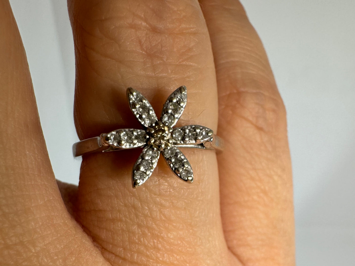 14K gold ring set with a floral design with six petal-shaped segments, each pavé-set with shimmering Diamonds