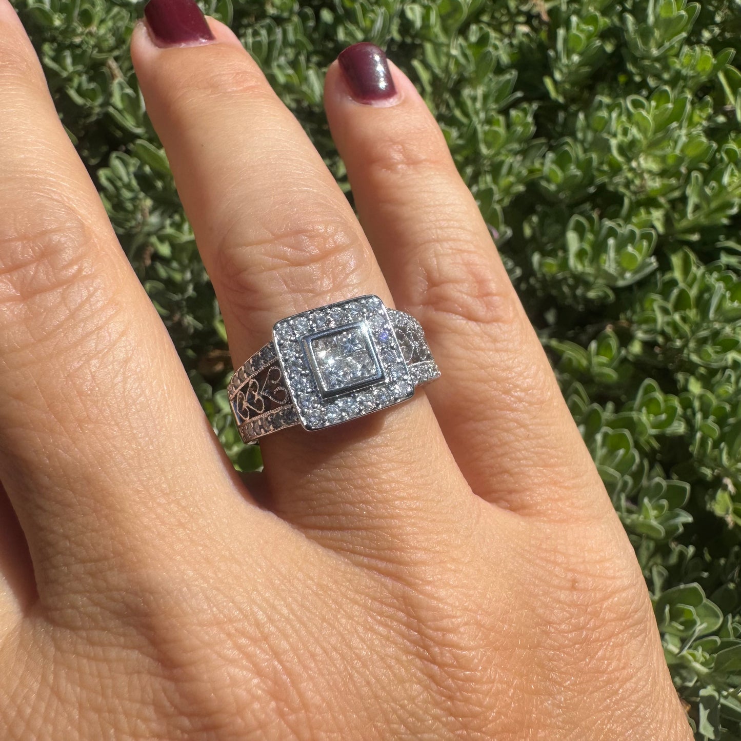 14K gold ring featuring a square cluster of princess-cut Diamonds in the center, surrounded by a double halo of smaller round Diamonds & gold details along the band.