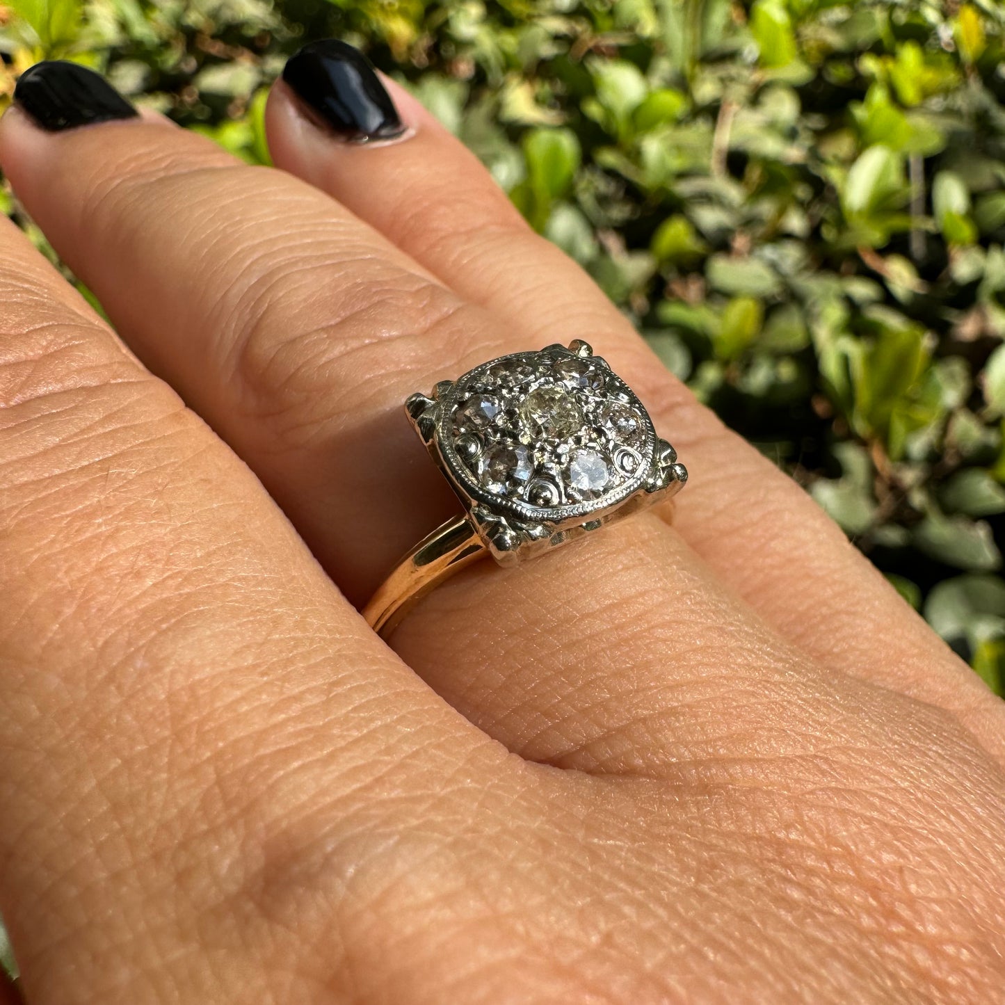 14K gold ring set with an old-cut Diamond at its center, encircled by a pavé cluster of smaller Diamonds in a round, ornate setting.