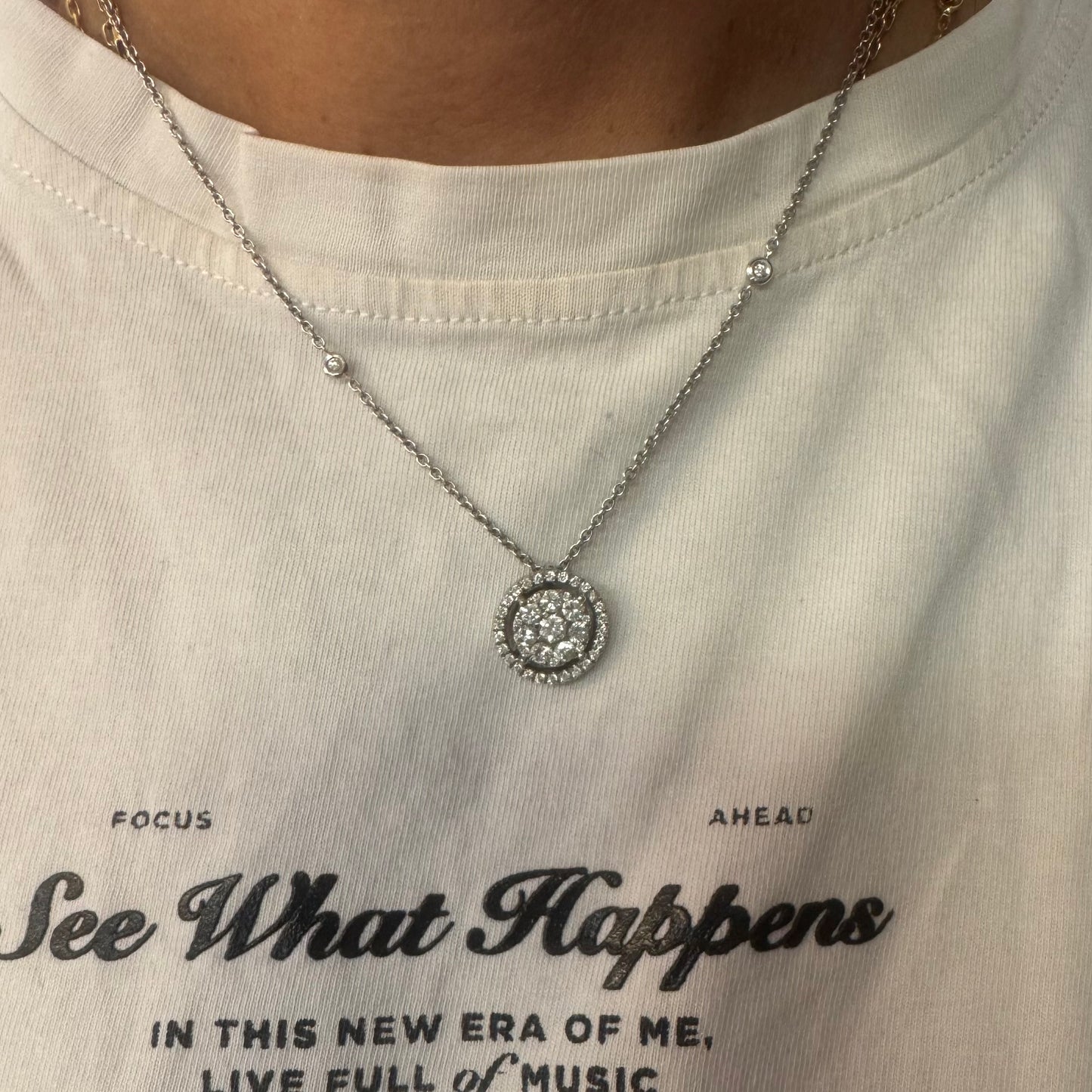 14K gold necklace featuring a round pendant set with a cluster of sparkling Diamonds