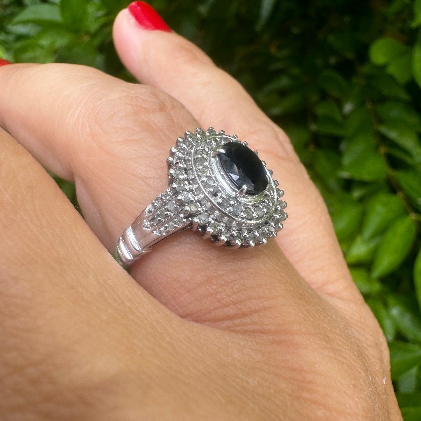 14K gold ring set with an oval-cut Sapphire, surrounded by a stunning double halo of brilliant round Diamonds