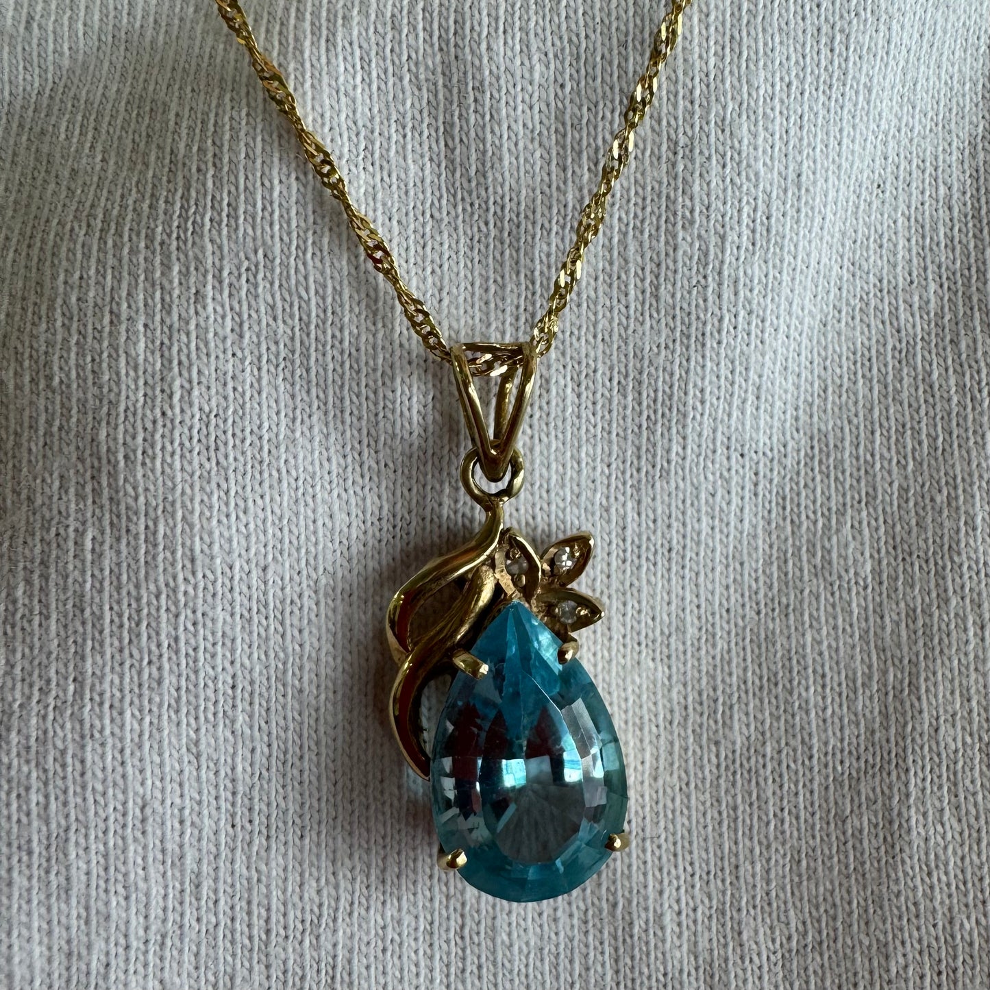 14K gold necklace set with Blue Topaz pendant in a teardrop cut