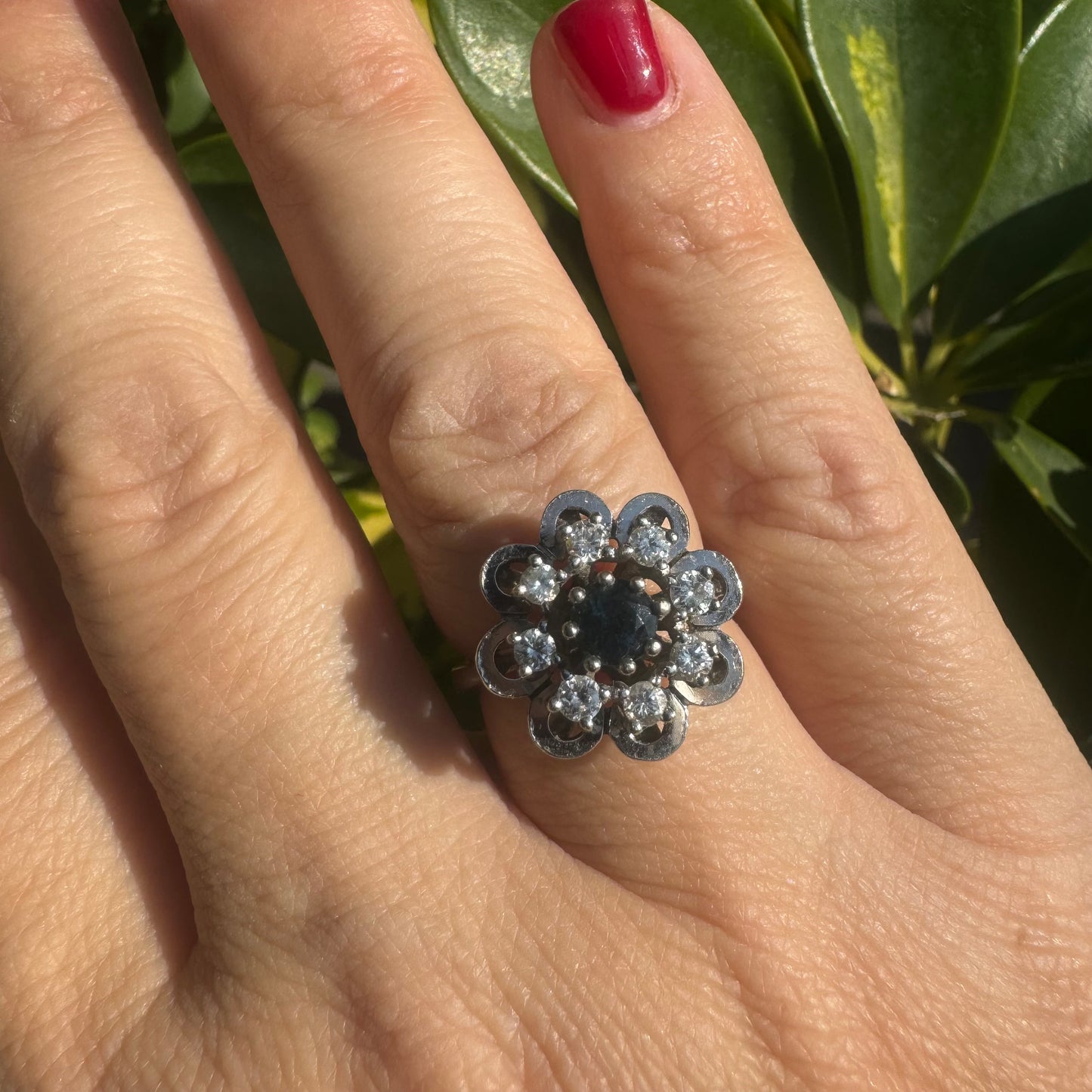 14K gold floral ring set with a round deep blue Sapphire at its center & Diamonds