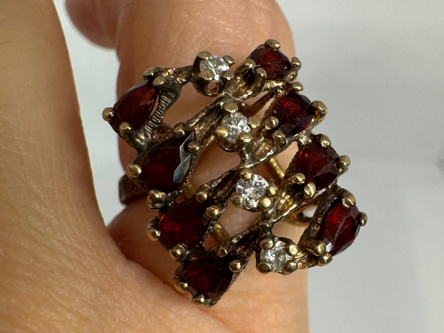 14K gold ring set with deep red teardrop Garnets and sparkling Diamonds in an openwork geometric design