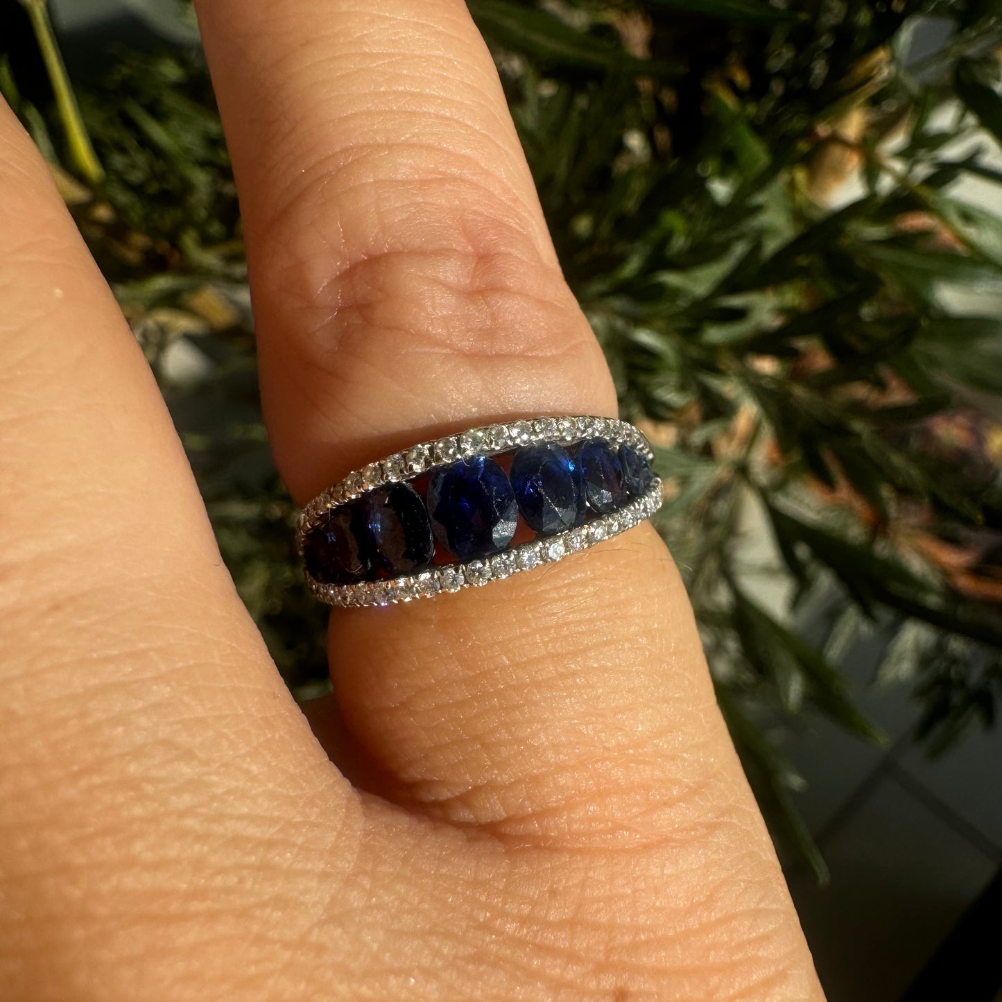 18K gold ring set with a row of deep blue Sapphire & Diamonds