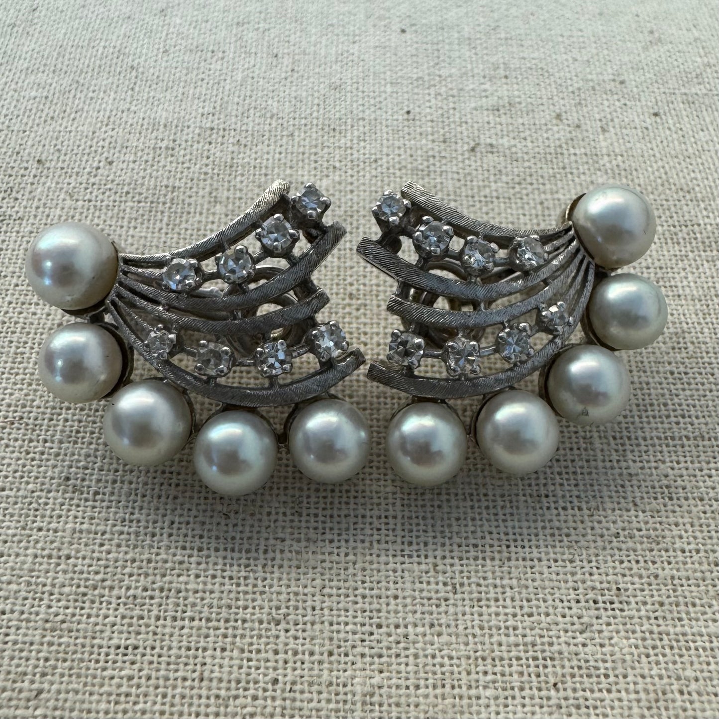 14K gold clip-on earrings inspired by 1950s Hollywood style, set with a row of luminous round pearls & Diamonds