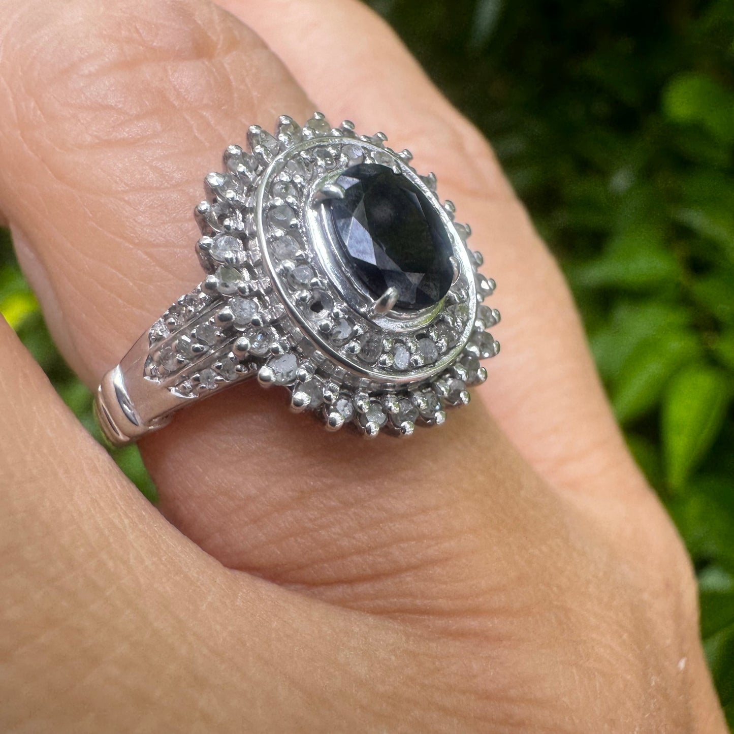 14K gold ring set with an oval-cut Sapphire, surrounded by a stunning double halo of brilliant round Diamonds