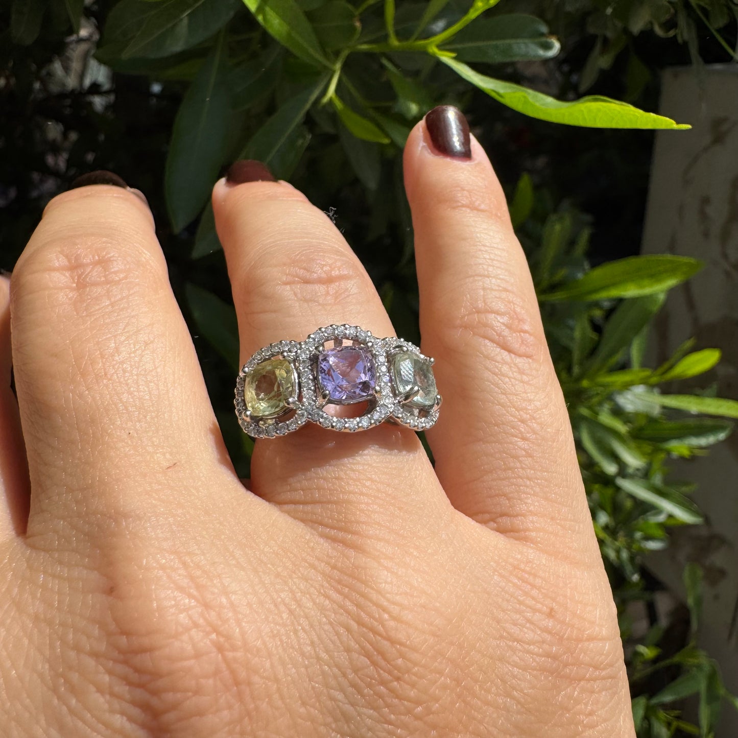 18K gold ring set with three pastel gemstones in soft shades of lilac, yellow and light gray