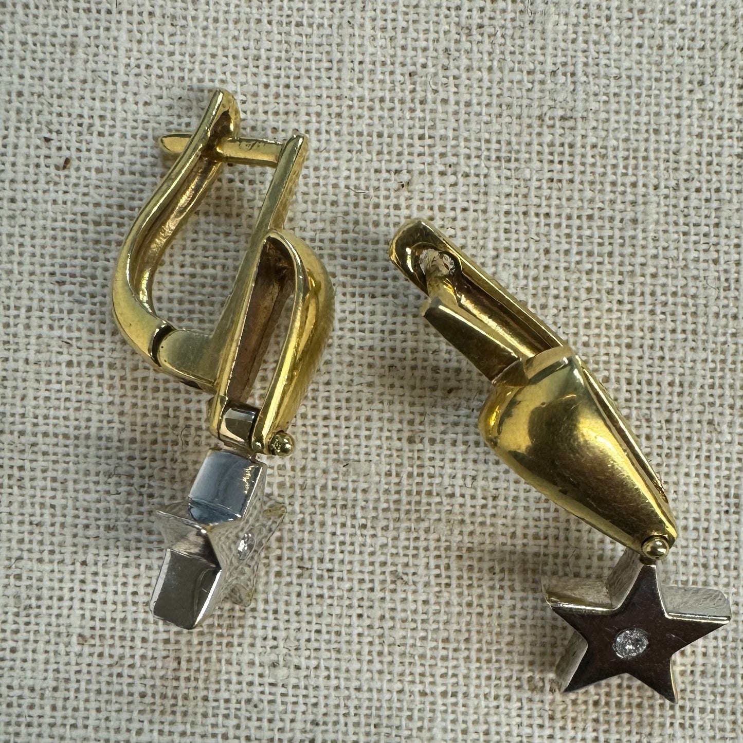 18K gold earrings set with a sparkling Diamond at the center.