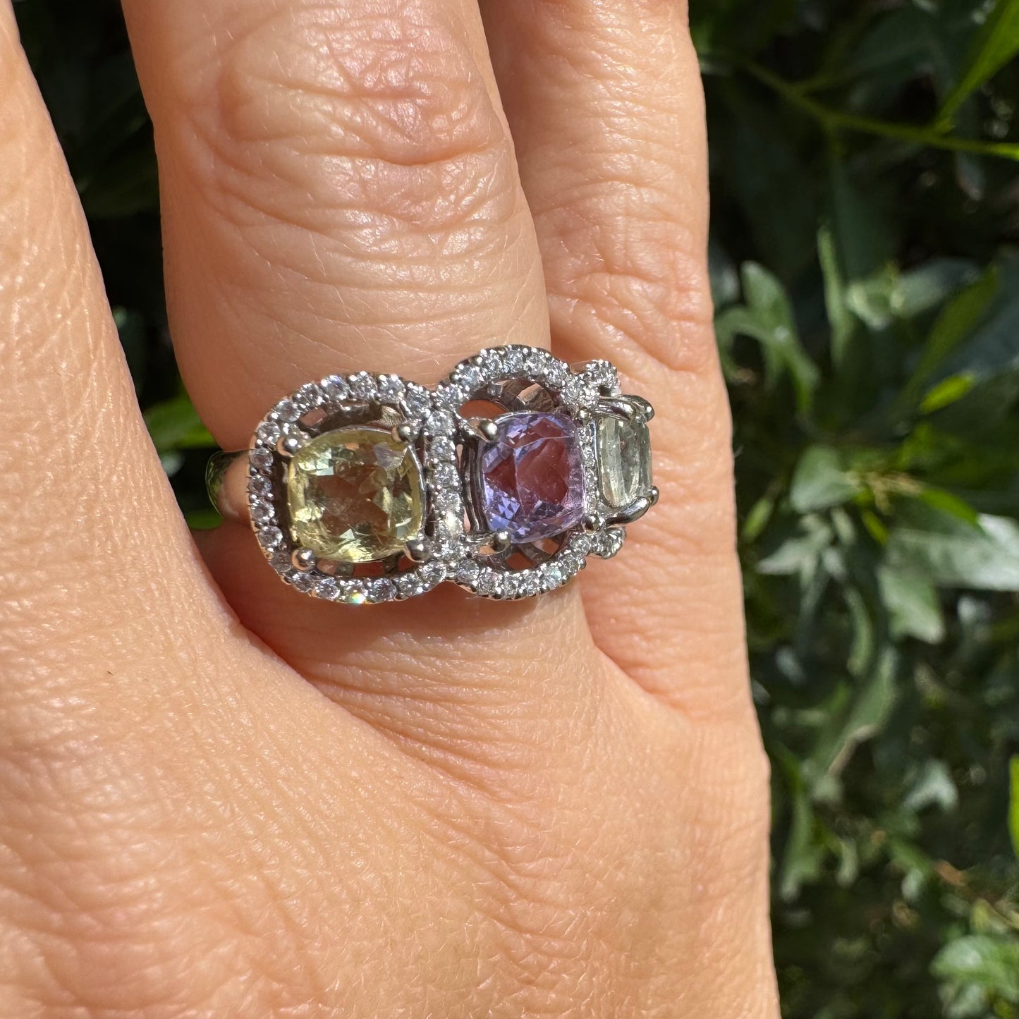 18K gold ring set with three pastel gemstones in soft shades of lilac, yellow and light gray