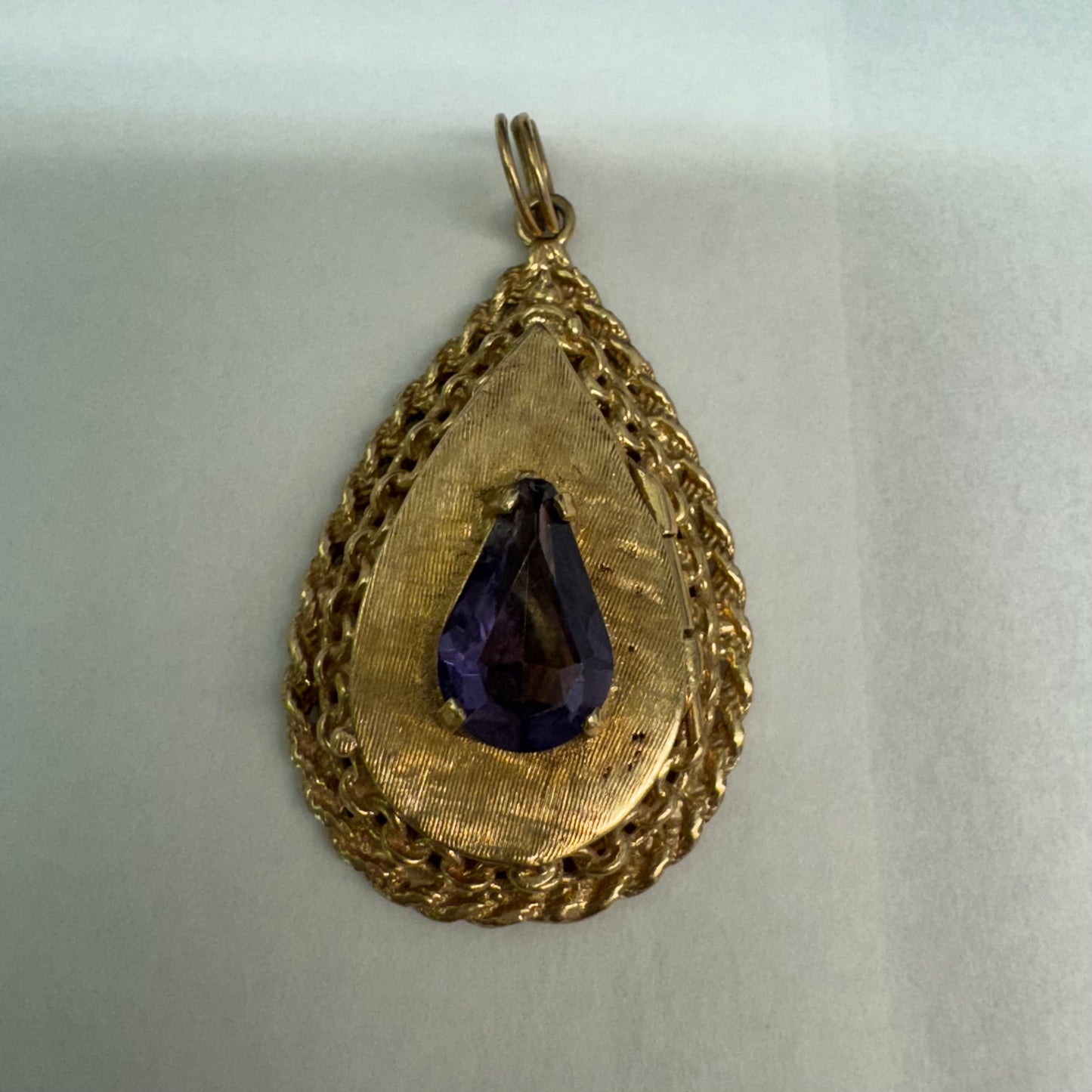14K gold locket pendant set with an Amethyst gemstone