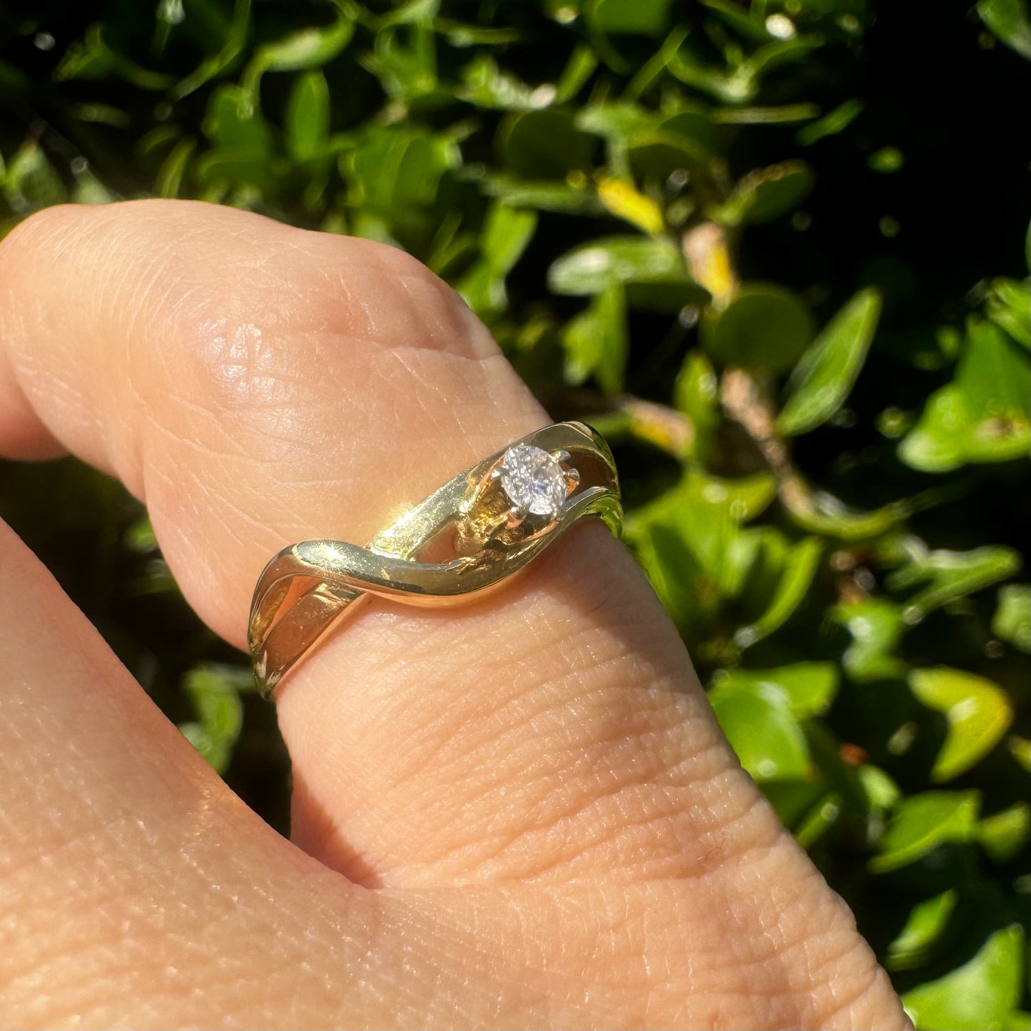 14K gold ring set with a single brilliant-cut diamond