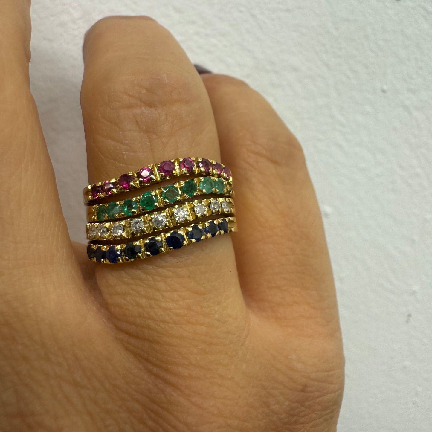 18K yellow gold ring set with vibrant rows of Sapphires, Emeralds, Rubies, and Diamonds