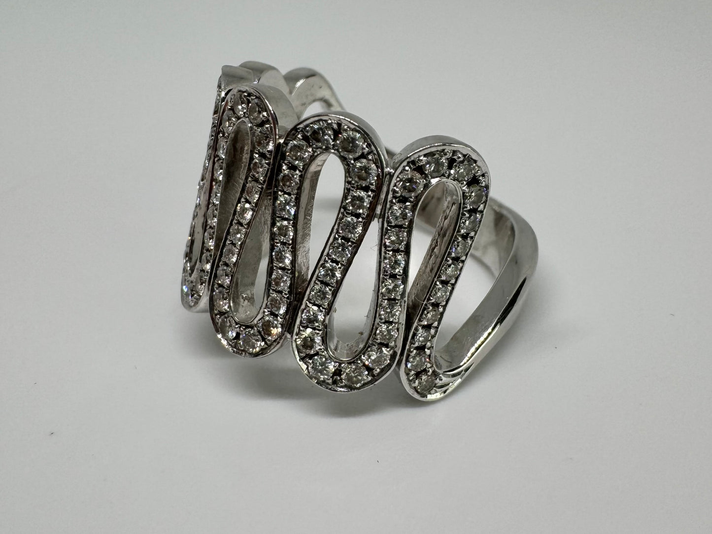 14K gold ring set with shimmering Diamonds in a flowing wave design