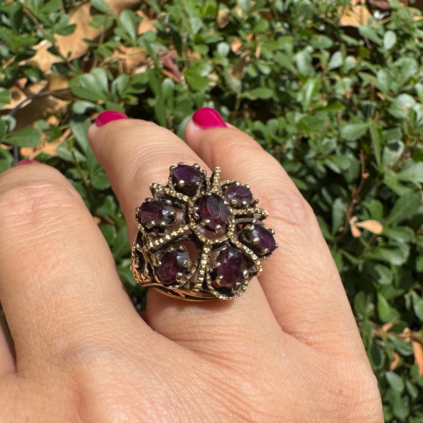 14K gold cocktail ring set with a stunning cluster of deep purple Garnet stones in marquise cuts.