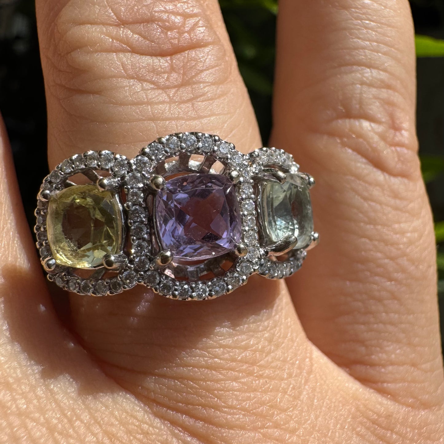 18K gold ring set with three pastel gemstones in soft shades of lilac, yellow and light gray