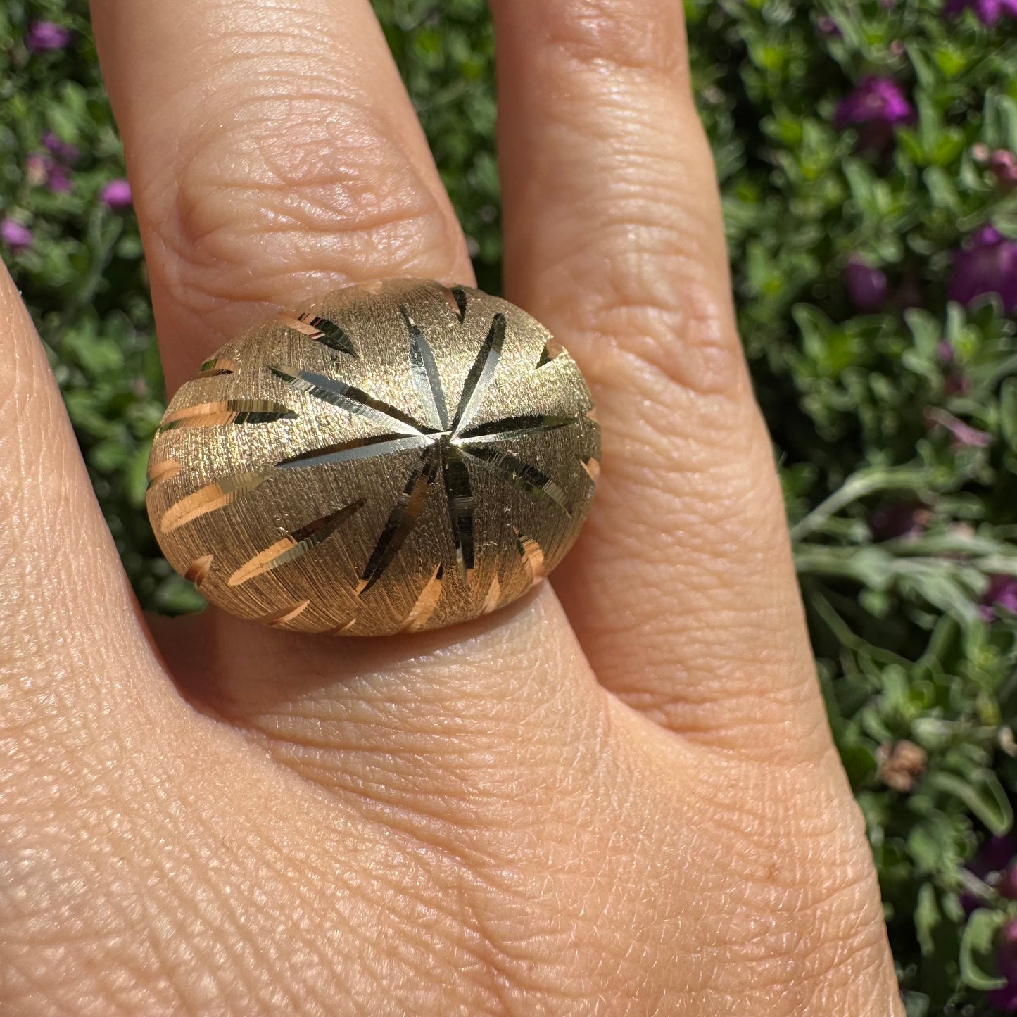 14K gold dome ring crafted in textured gold, featuring intricate engraved starburst detailing