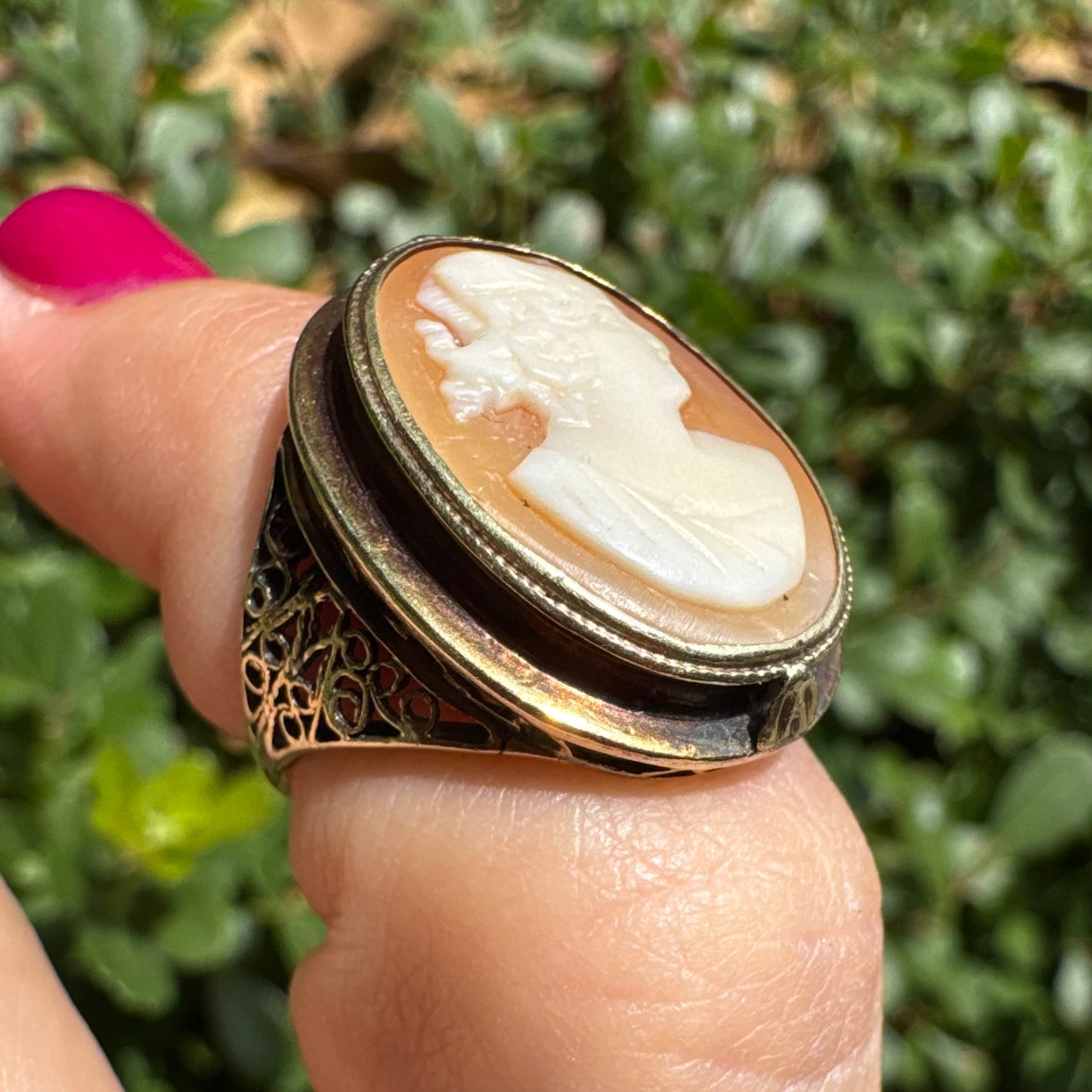 14K gold cameo ring featuring a finely carved portrait of a woman in profile, set in an oval bezel with intricate gold detailing