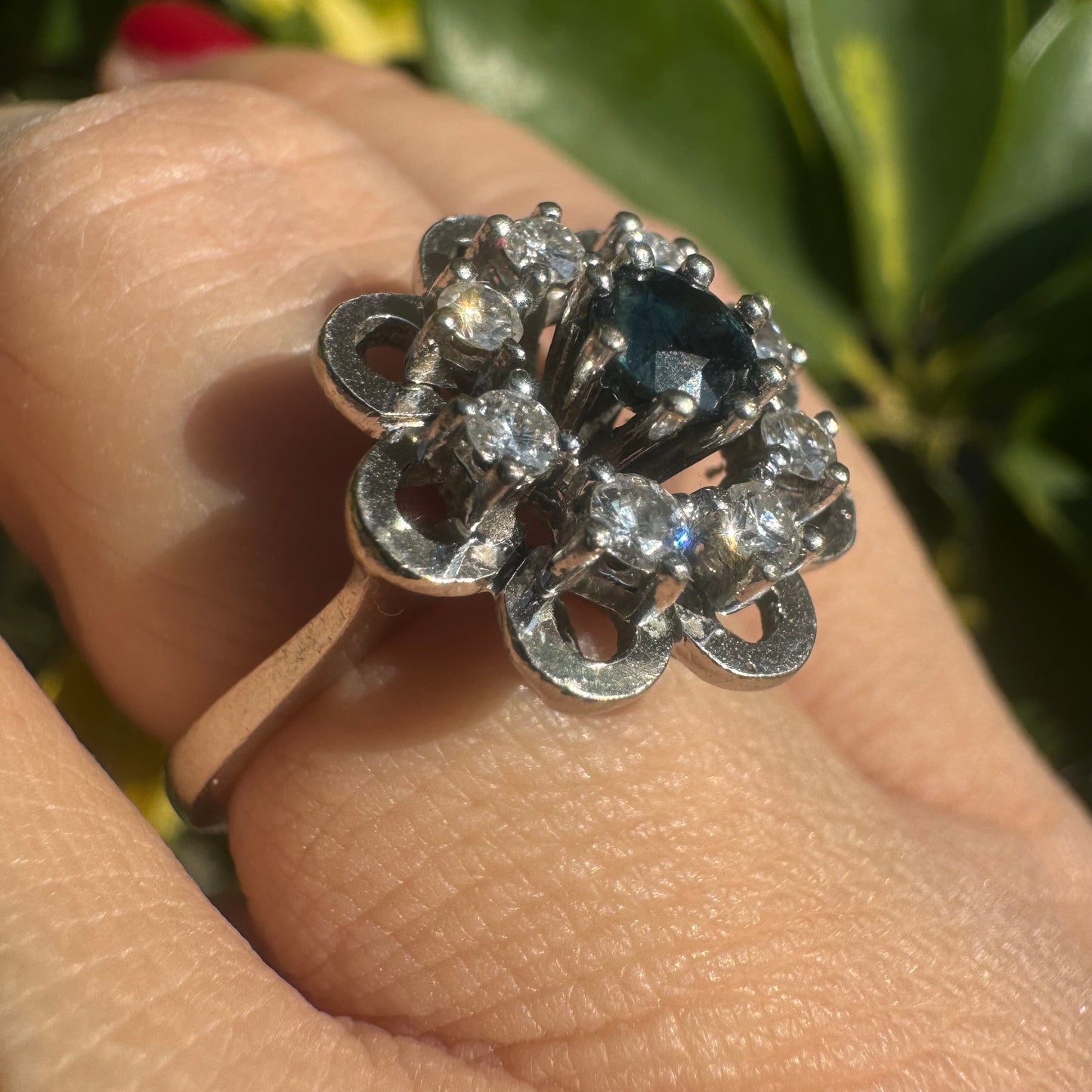 14K gold floral ring set with a round deep blue Sapphire at its center & Diamonds