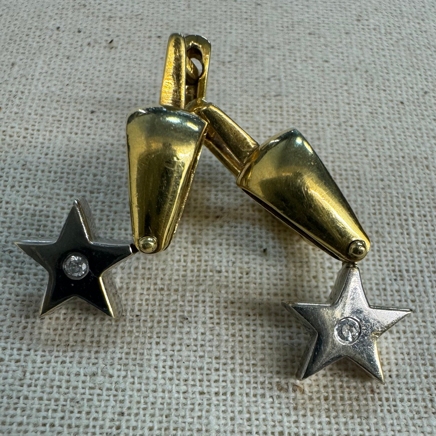 18K gold earrings set with a sparkling Diamond at the center.