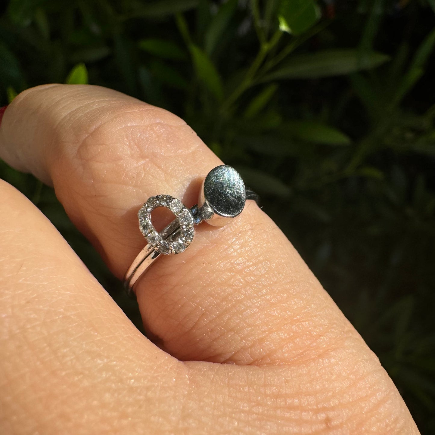 14K gold open ring featuring two ends: one with a sparkling oval of Diamonds and the other with a smooth polished oval.