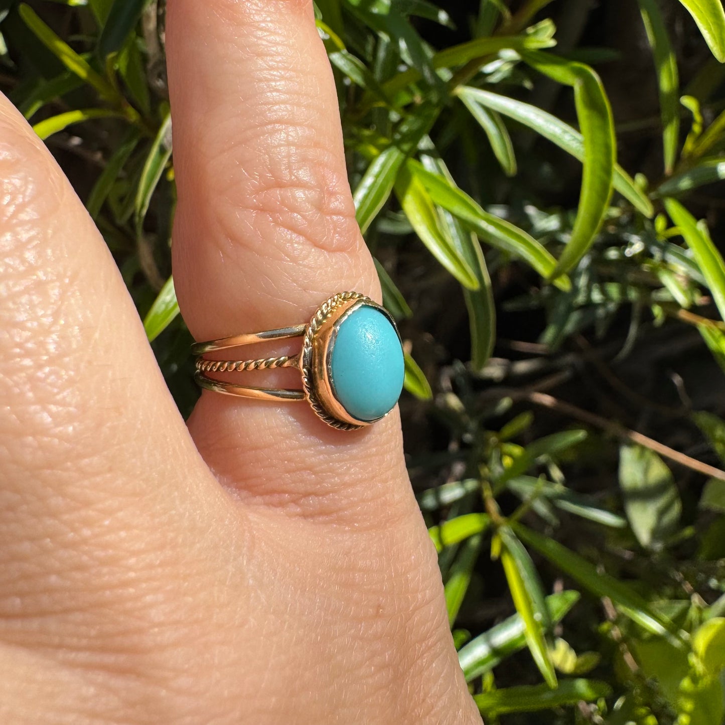 14K gold ring set with an oval Turquoise stone in a delicate rope-style bezel