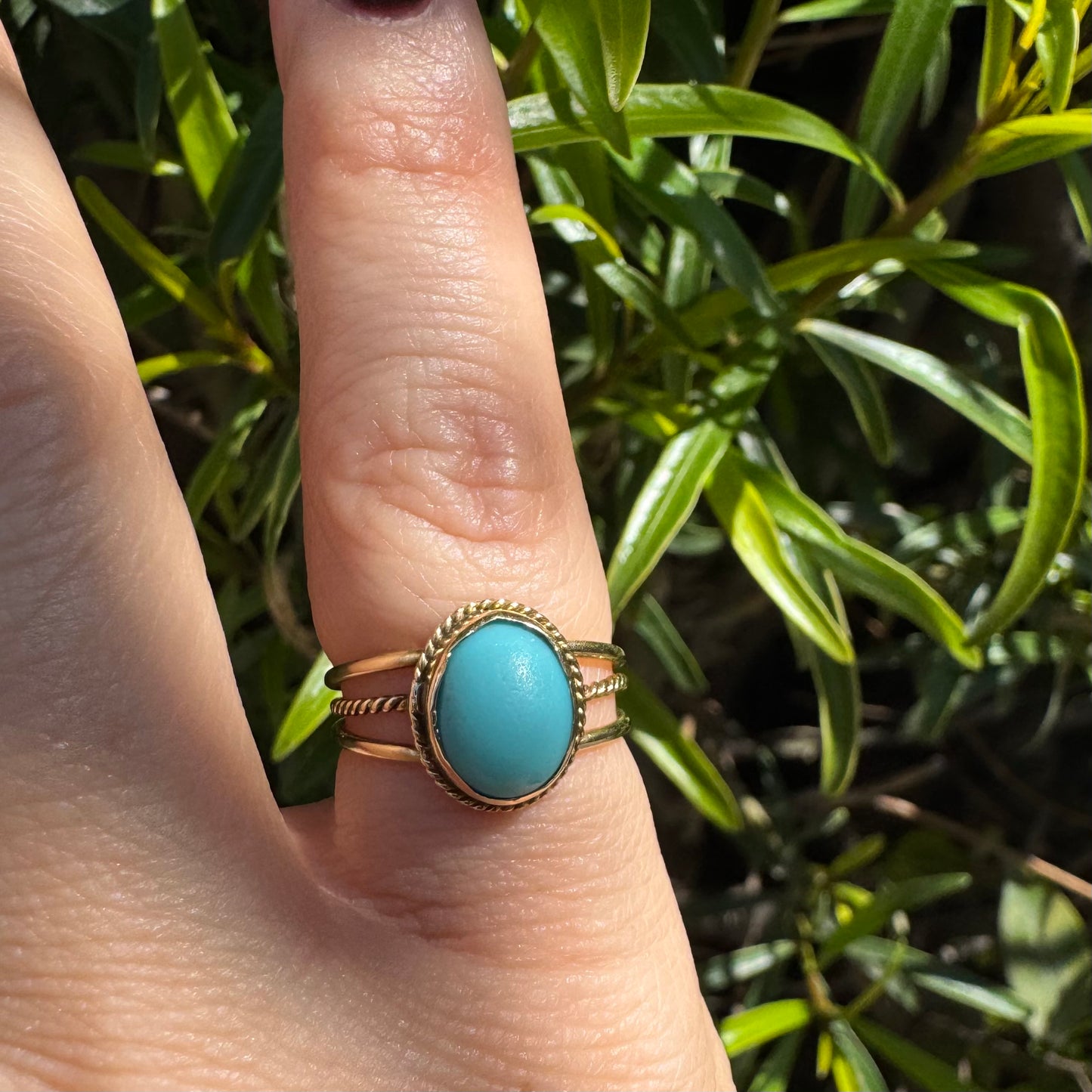 14K gold ring set with an oval Turquoise stone in a delicate rope-style bezel