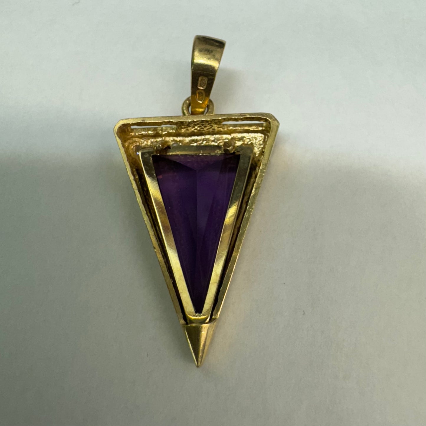 14K yellow gold pendant set with a triangular-cut amethyst and three accent diamonds