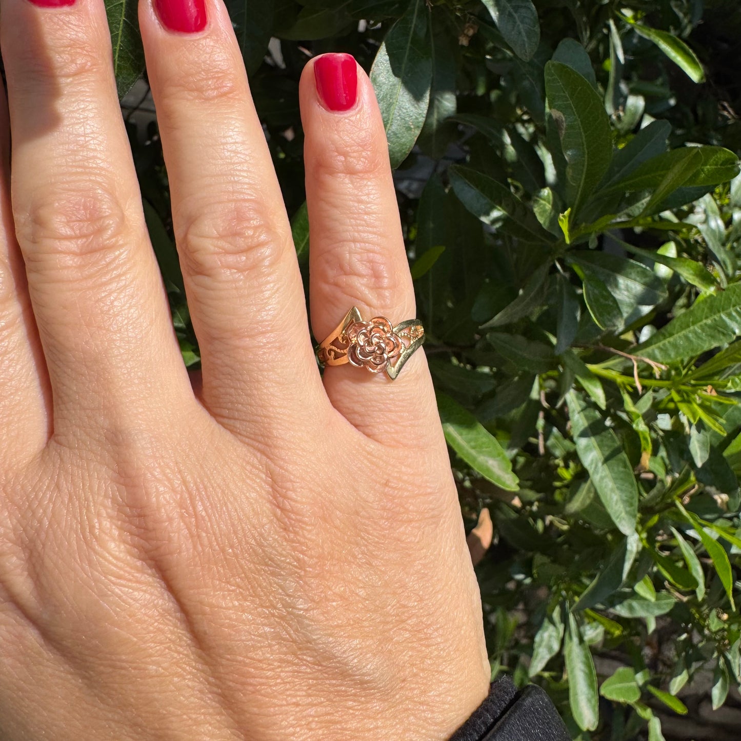 10K two tone gold with a sculpted rose at its center