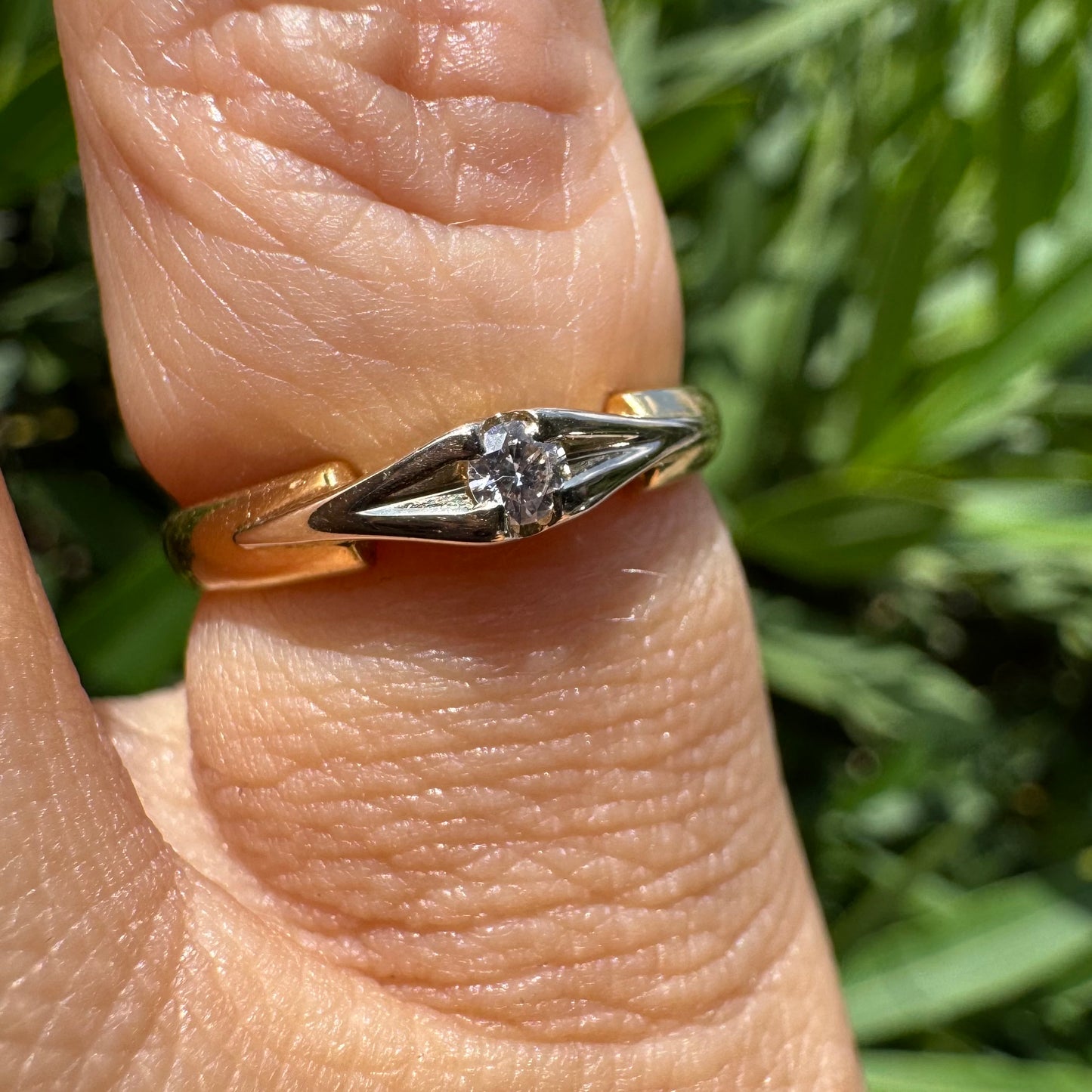 18K gold ring featuring a single round Diamond