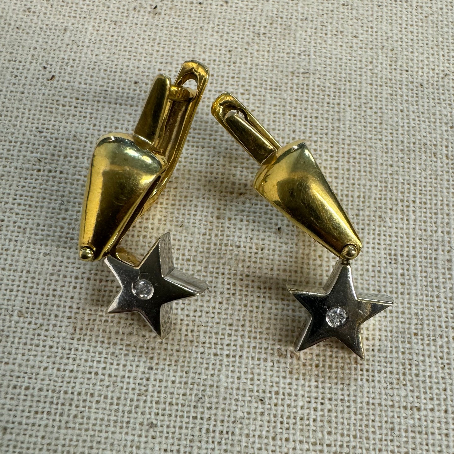 18K gold earrings set with a sparkling Diamond at the center.