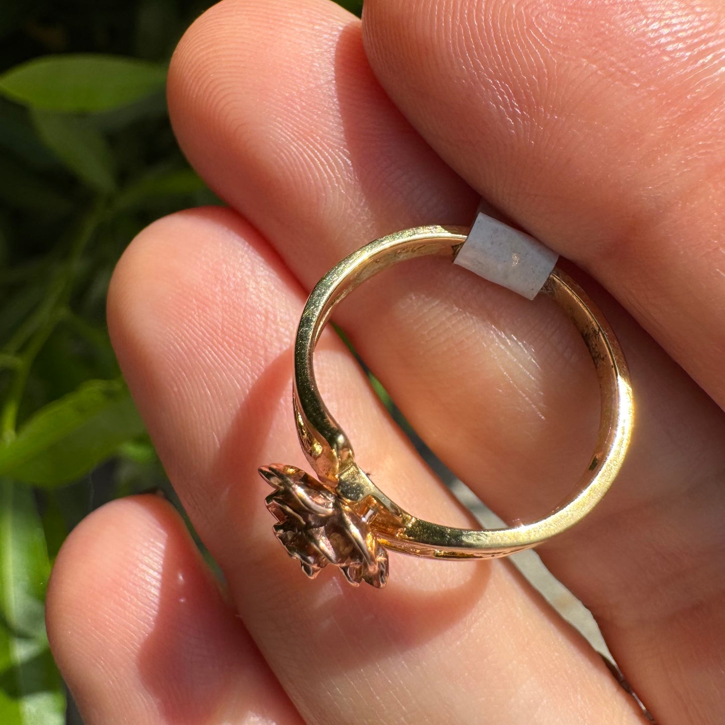 10K two tone gold with a sculpted rose at its center