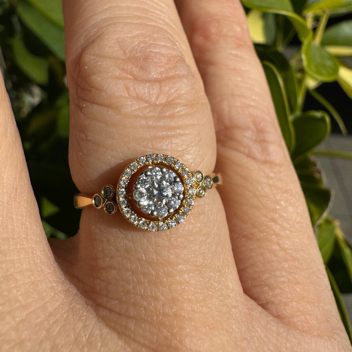 14K gold ring with a round cluster of Diamonds in the center, surrounded by a halo of smaller sparkling Diamonds.