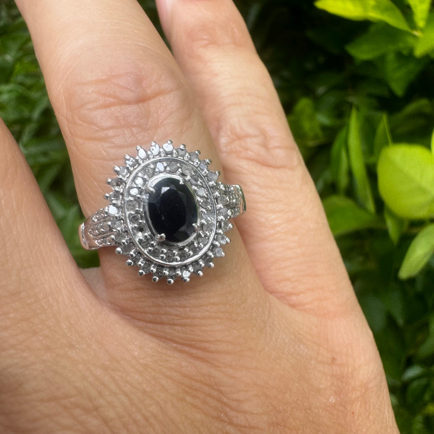 14K gold ring set with an oval-cut Sapphire, surrounded by a stunning double halo of brilliant round Diamonds