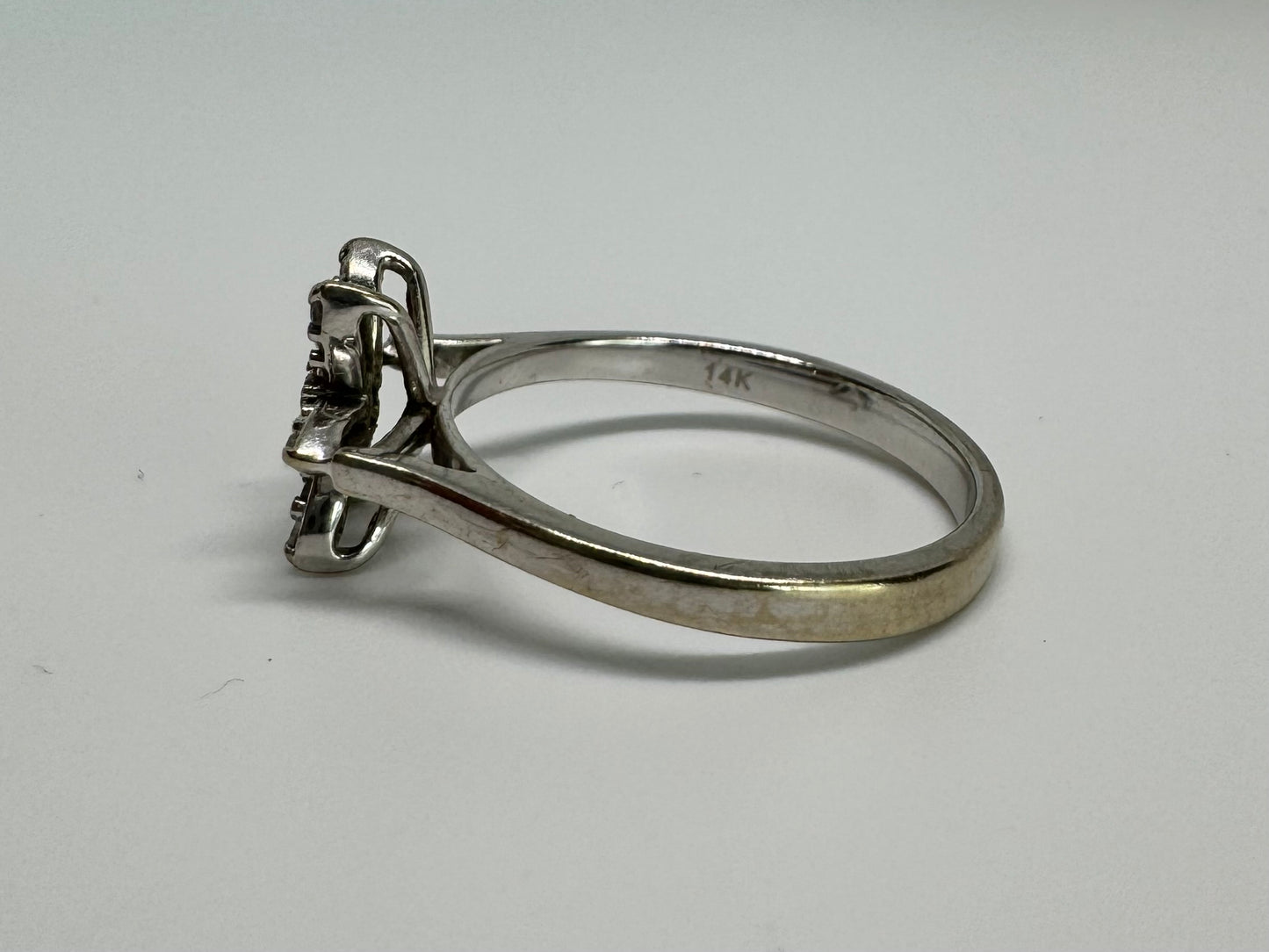 14K gold ring set with a floral design with six petal-shaped segments, each pavé-set with shimmering Diamonds