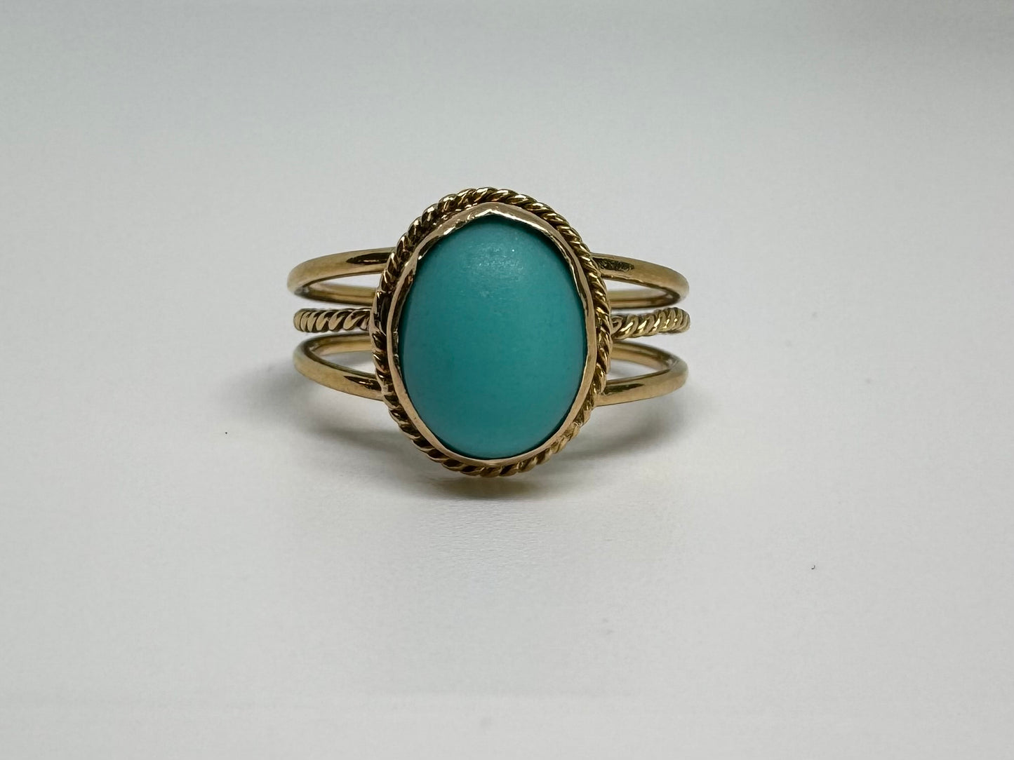 14K gold ring set with an oval Turquoise stone in a delicate rope-style bezel