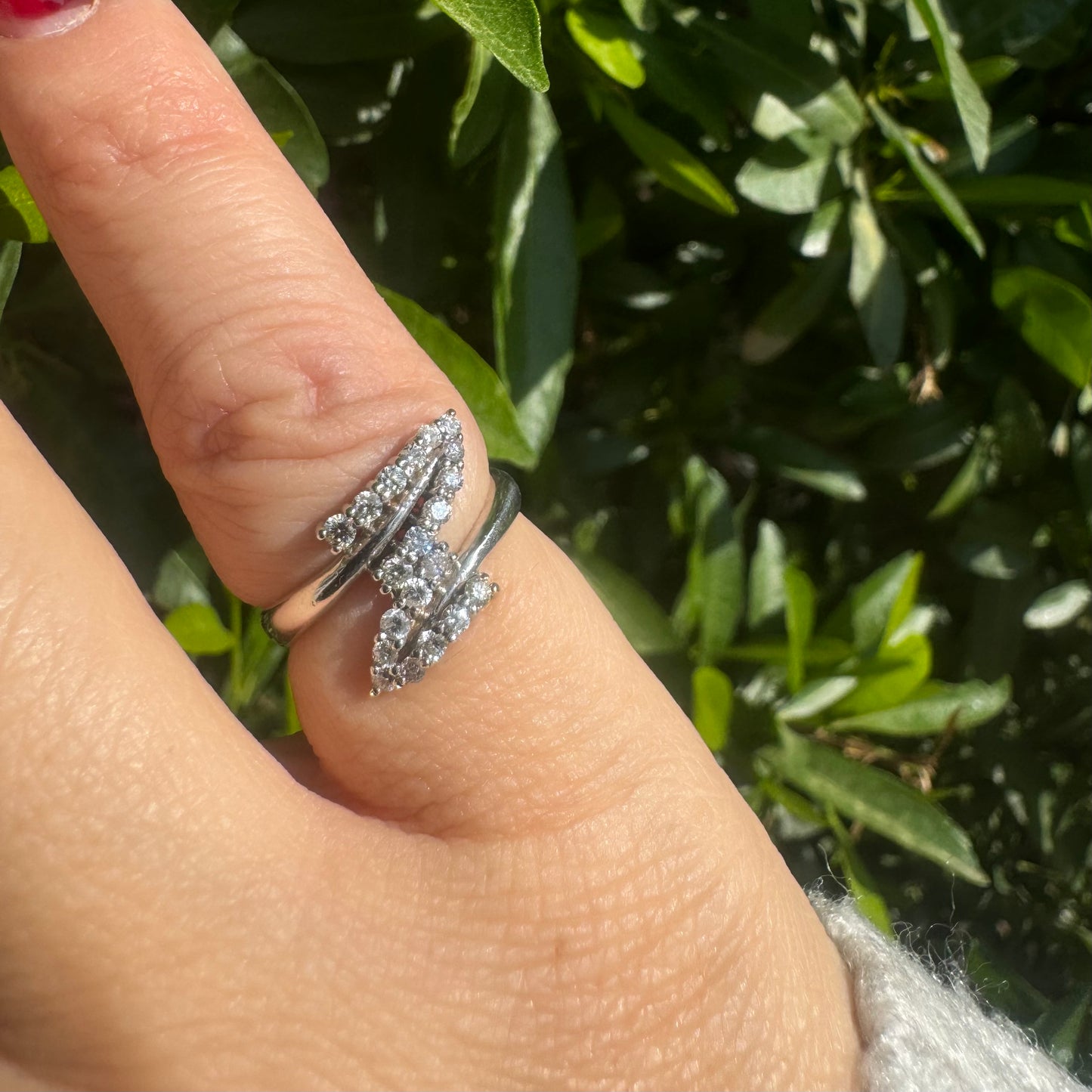 14K gold ring with an open design, featuring two curved rows of sparkling Diamonds that cross over each other elegantly.