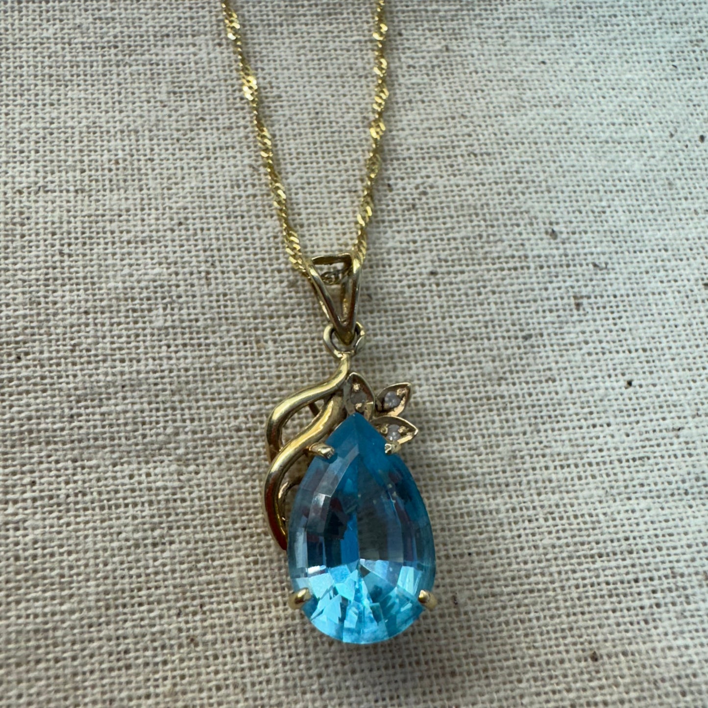 14K gold necklace set with Blue Topaz pendant in a teardrop cut