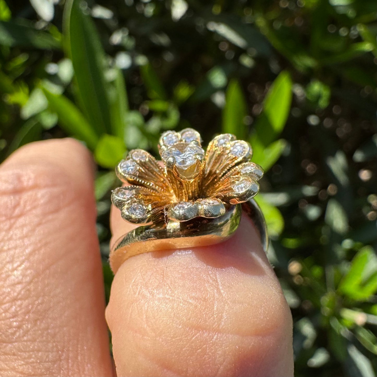 14K gold ring in a floral design, set with sparkling Diamonds at the center and around the petals.