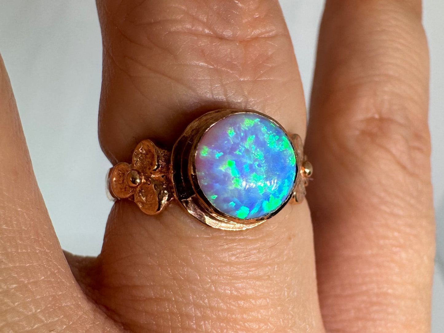 10K gold ring set with round Opal with vibrant flashes of blue, green and white