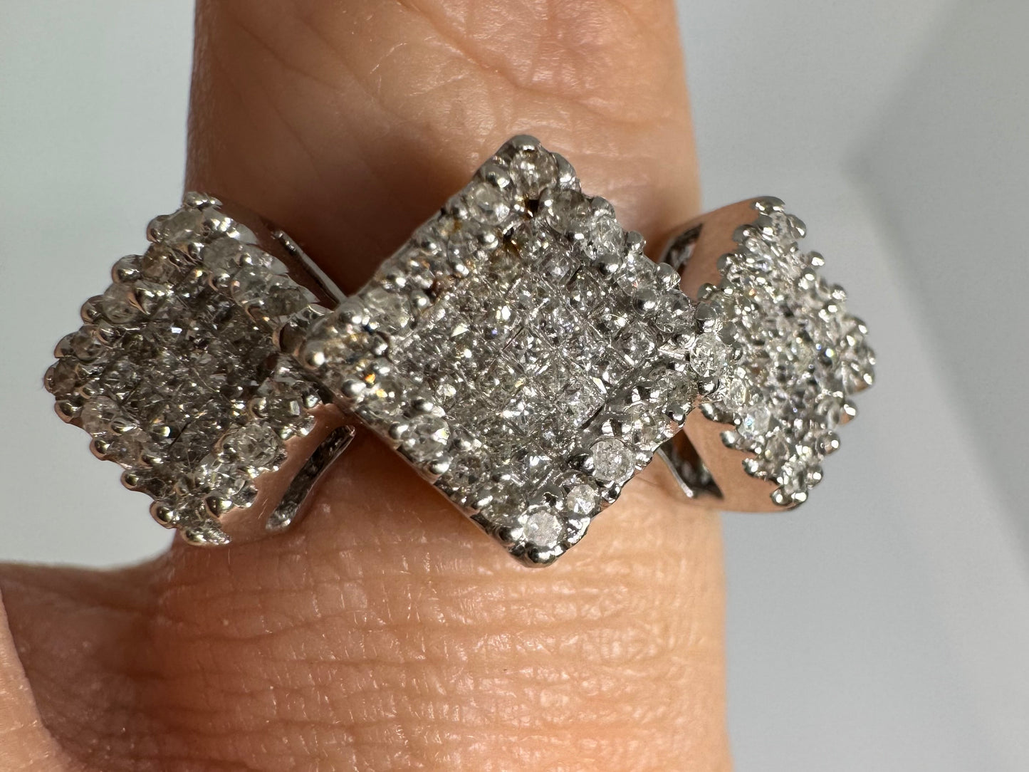 14K gold ring with three square clusters of sparkling Diamonds