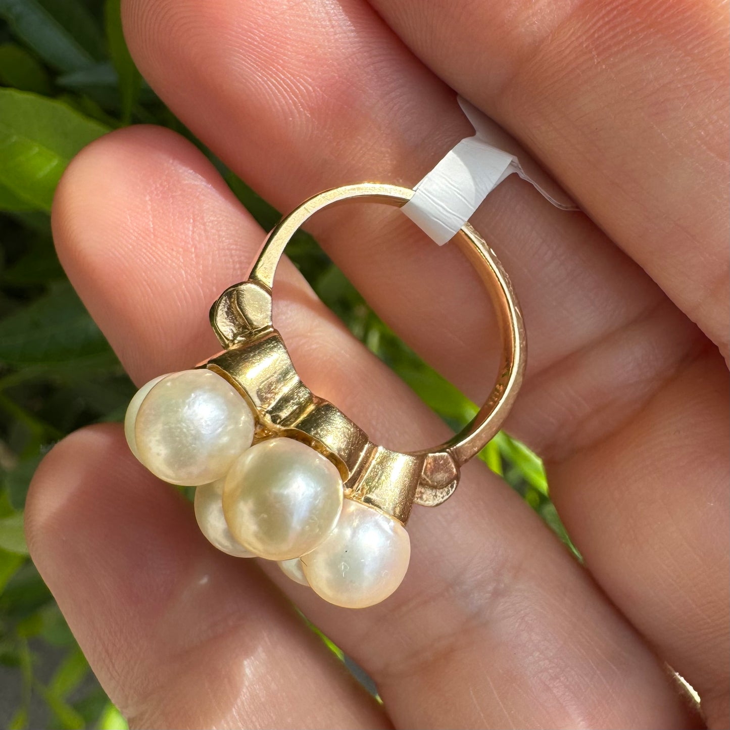 14K gold ring set with seven round Pearls in a bold floral cluster