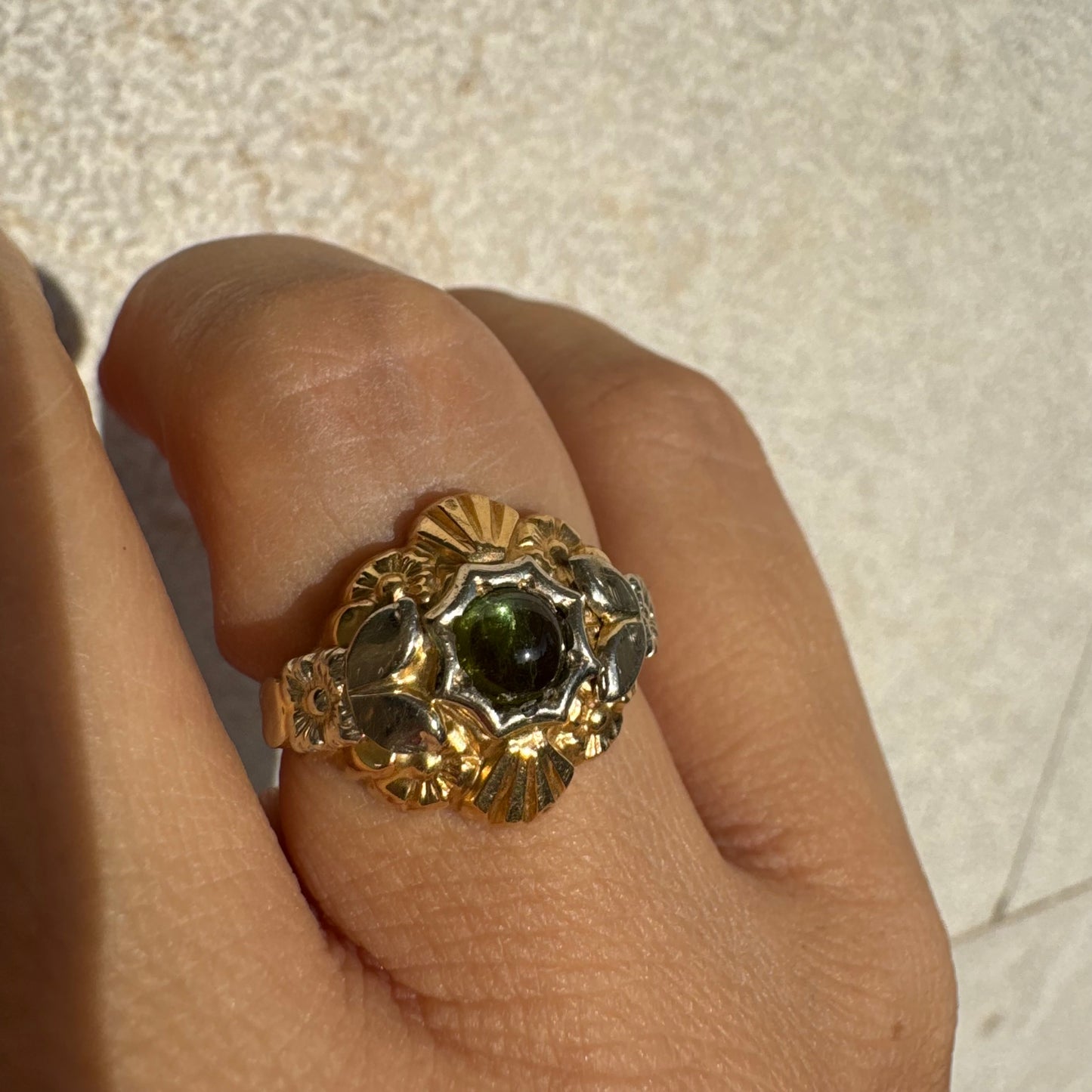 18K two-tone gold ring set with a deep green Tourmaline gemstone.