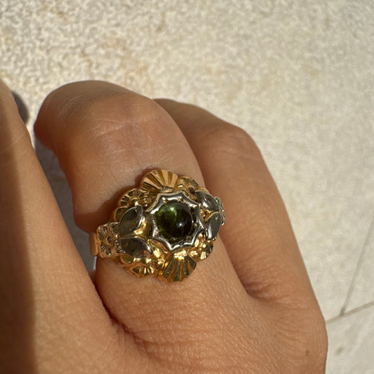 18K two-tone gold ring set with a deep green Tourmaline gemstone.