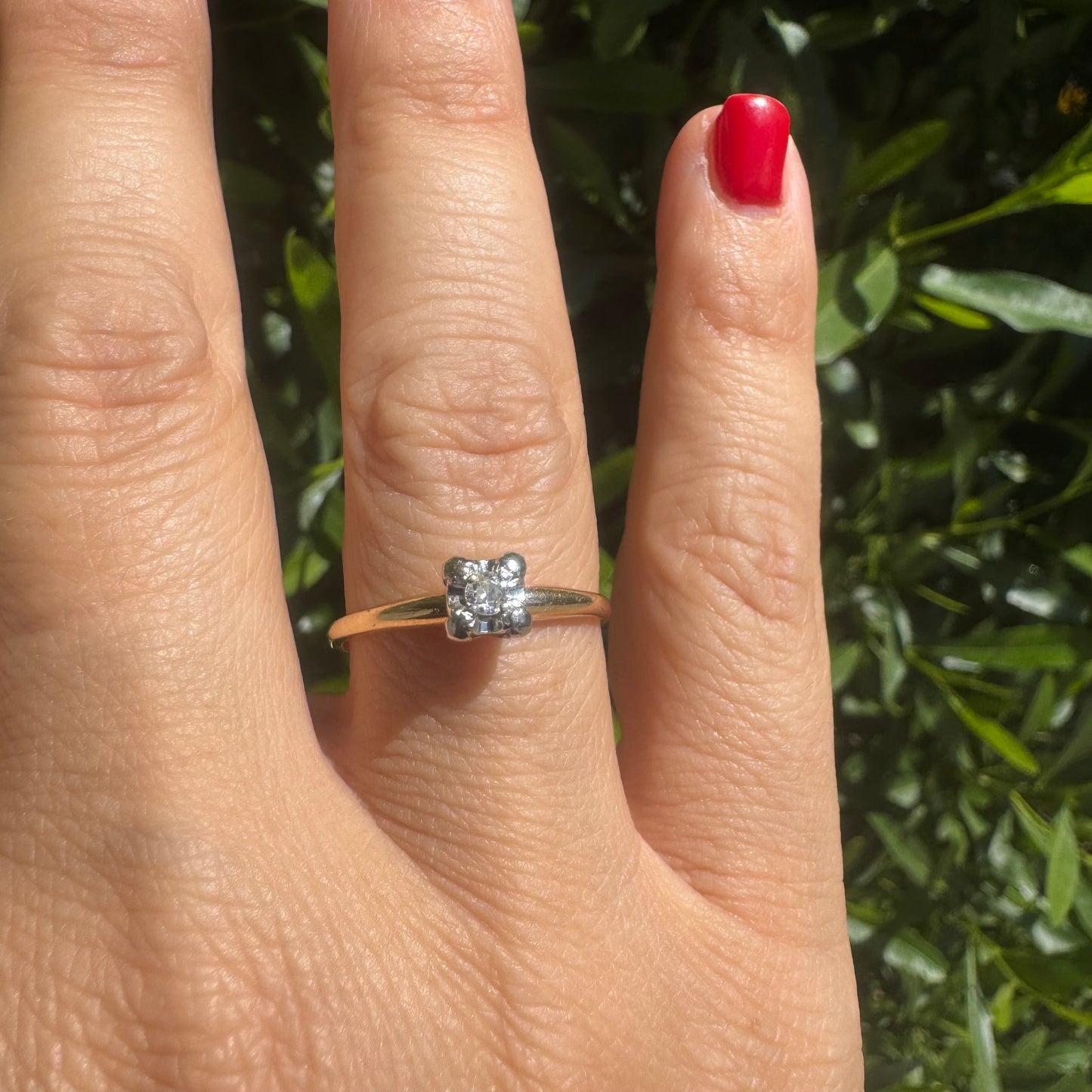 14K gold solitaire ring set with a small round Diamond