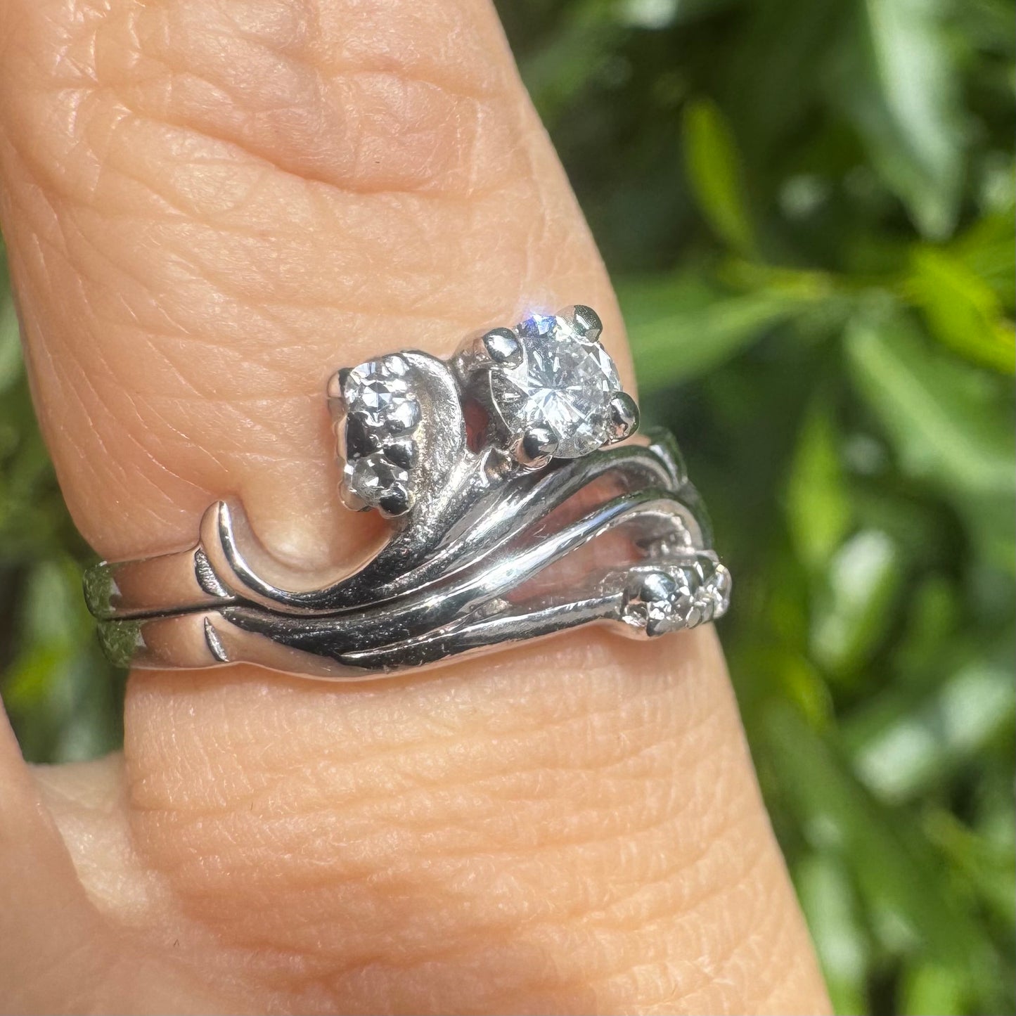 14K gold ring set with round-cut diamonds in a flowing design