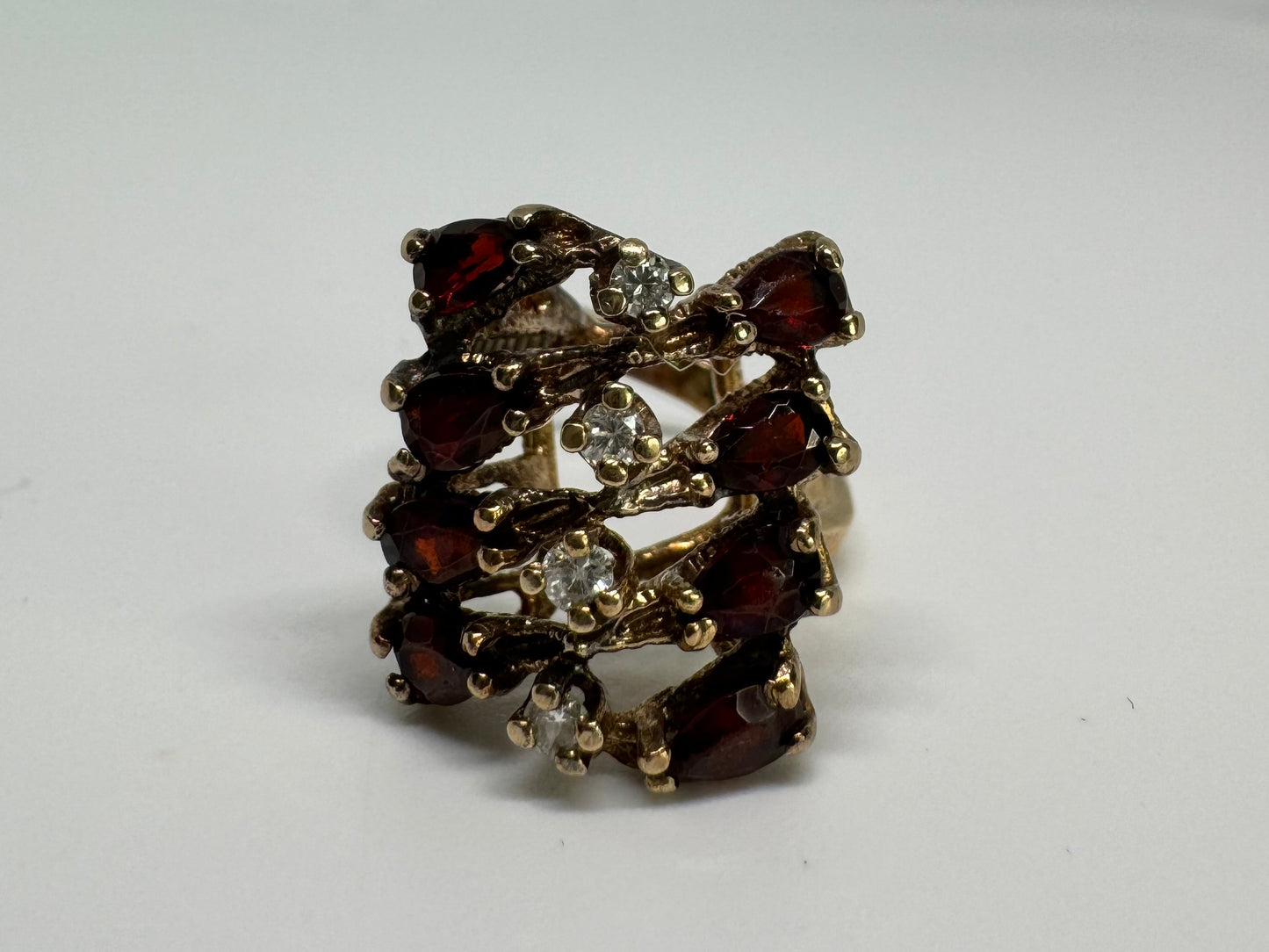 14K gold ring set with deep red teardrop Garnets and sparkling Diamonds in an openwork geometric design