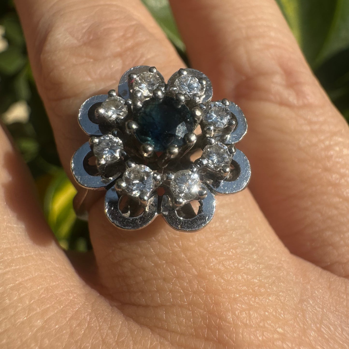 14K gold floral ring set with a round deep blue Sapphire at its center & Diamonds