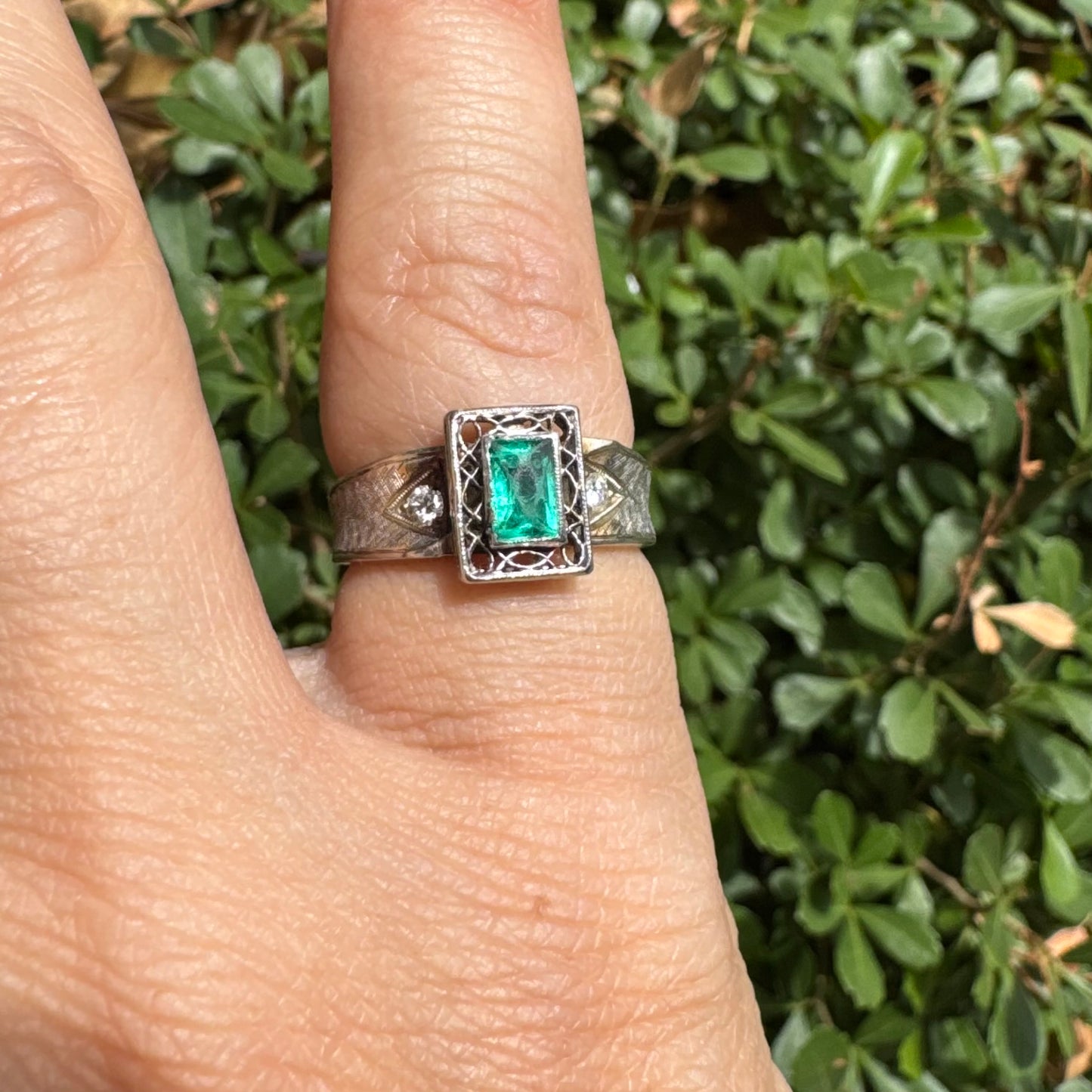 14K gold ring set with a vibrant emerald-cut Emerald at its center, framed by delicate filigree work